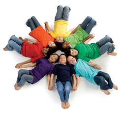 A circle formed by happy children lying on the ground.