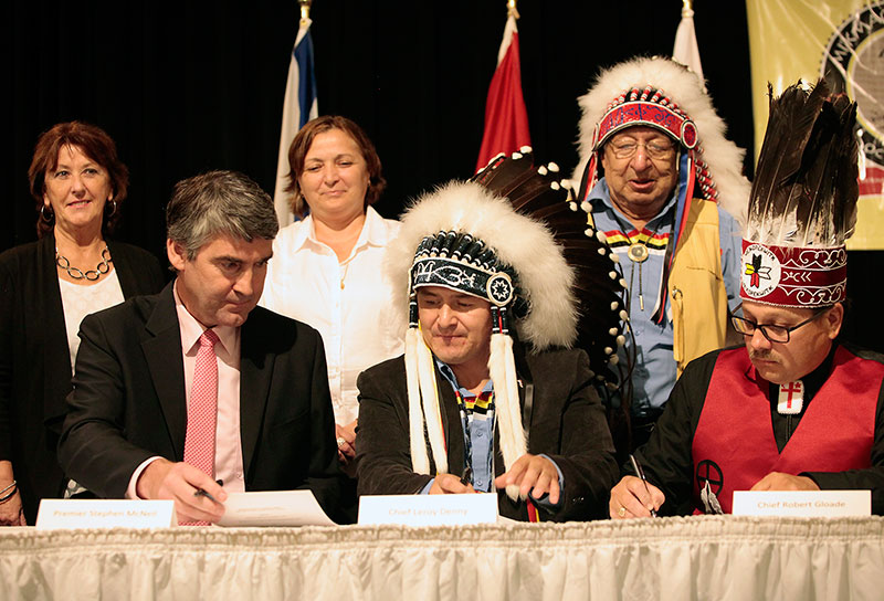 Premier Stephen McNeil, Chief Leroy Denny and Chief Robert Gloade sign the MOU on Treaty Day 2015.
